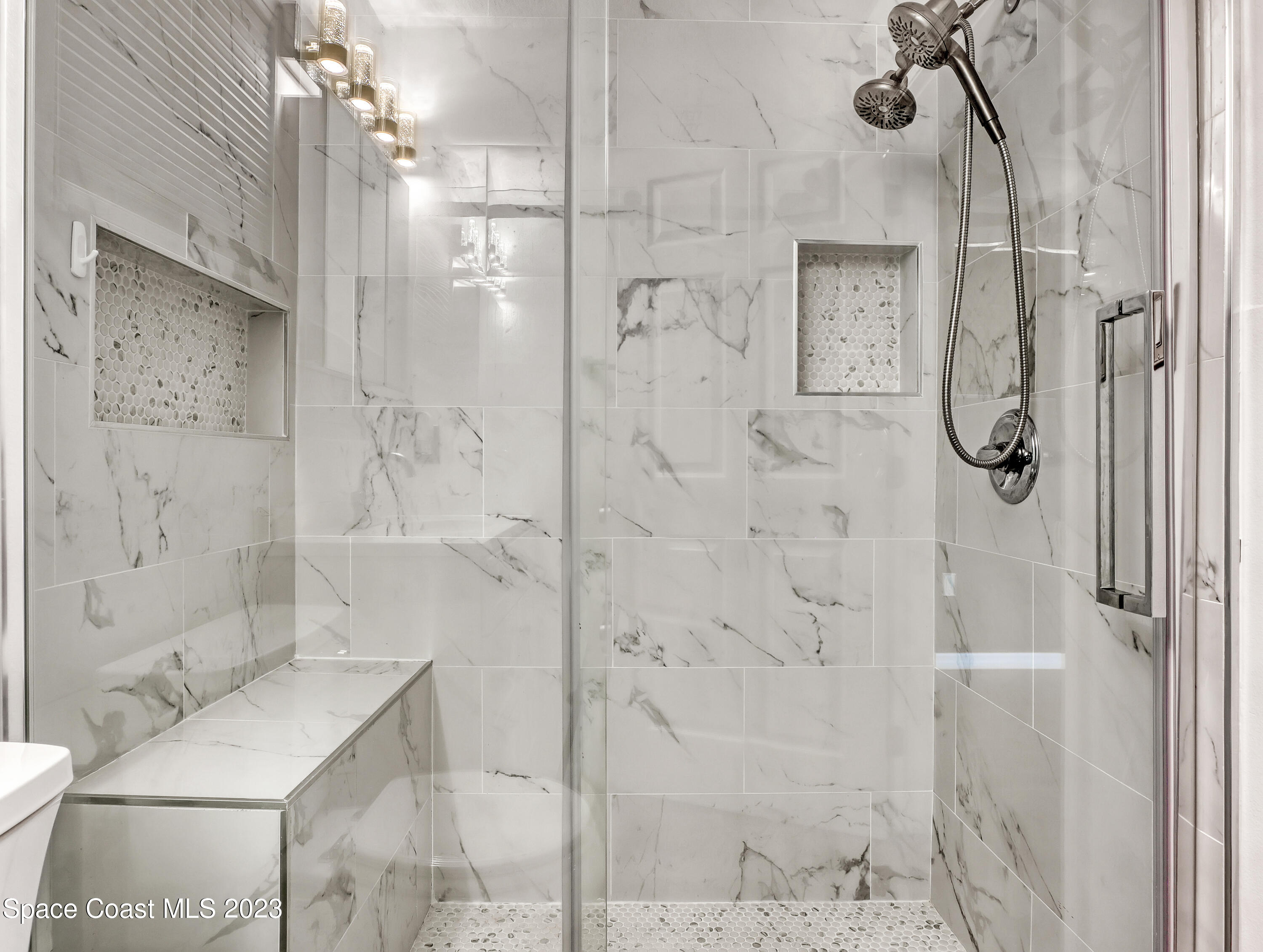 5233 Carrick Road Cocoa, FL 32927 - Photo 16 of 32 a bathroom with a granite countertop shower a toilet and sink