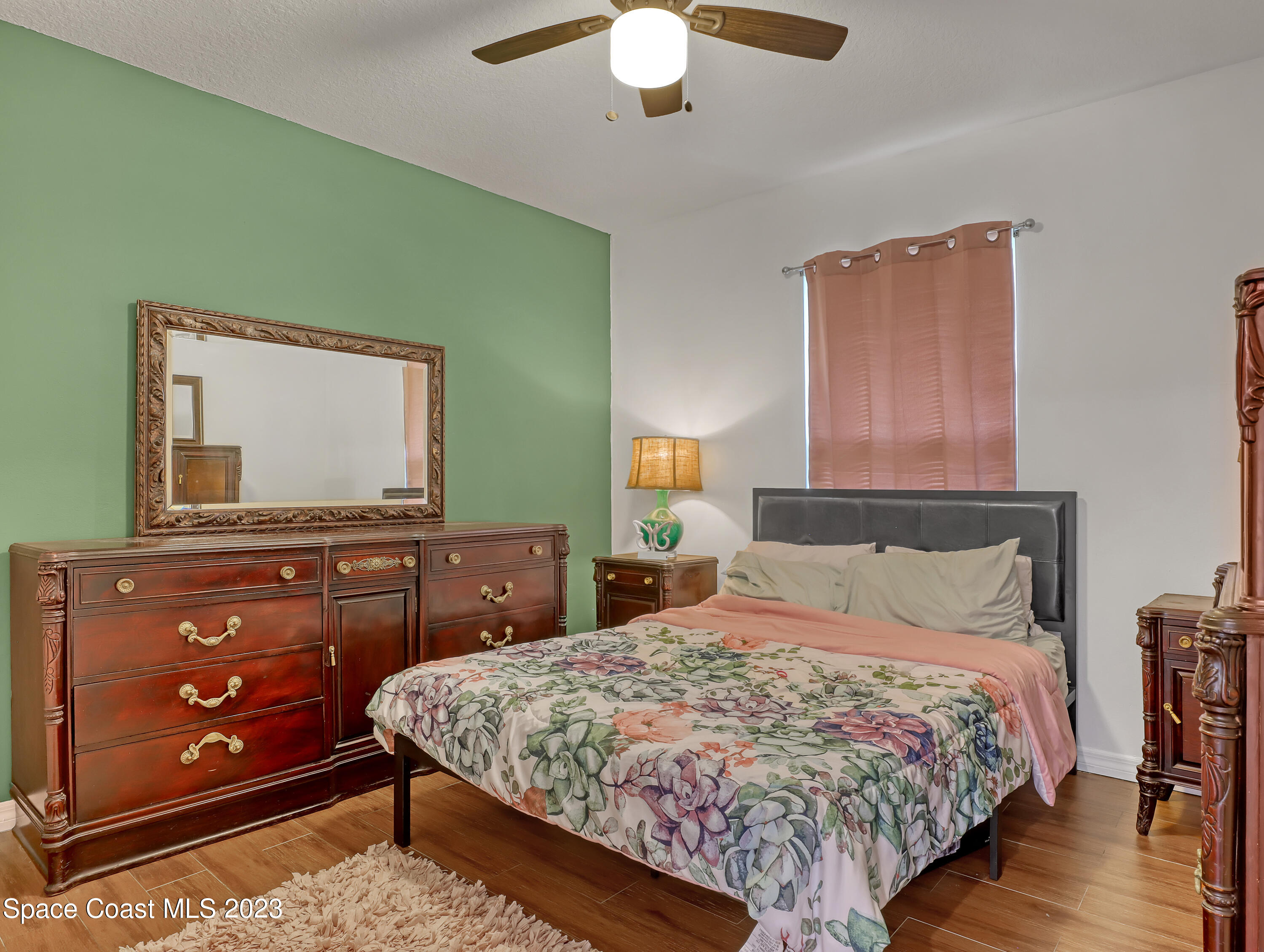 5233 Carrick Road Cocoa, FL 32927 - Photo 17 of 32 a bedroom with a bed and a dresser