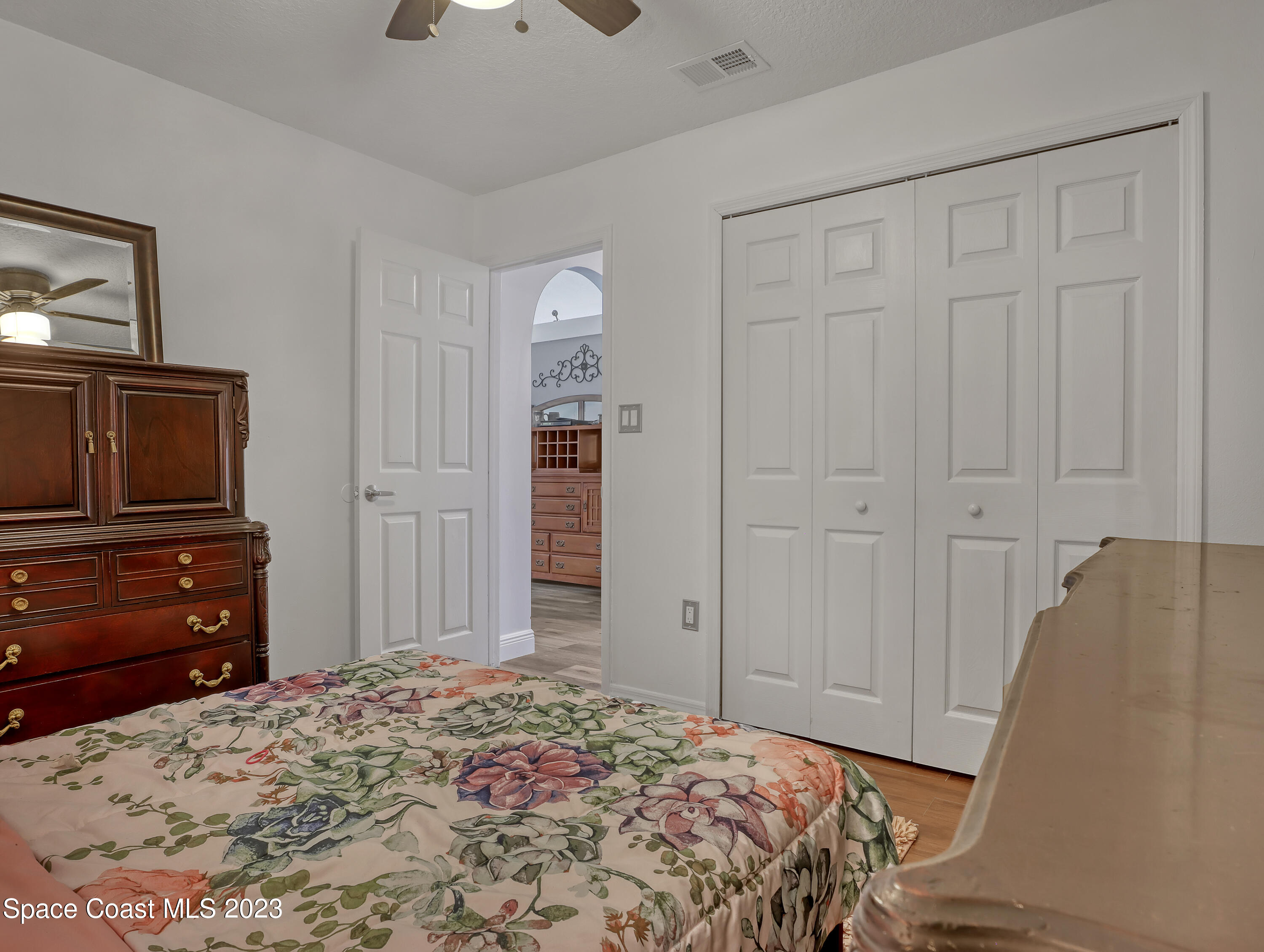5233 Carrick Road Cocoa, FL 32927 - Photo 18 of 32 a bedroom with a bed and a dresser in it