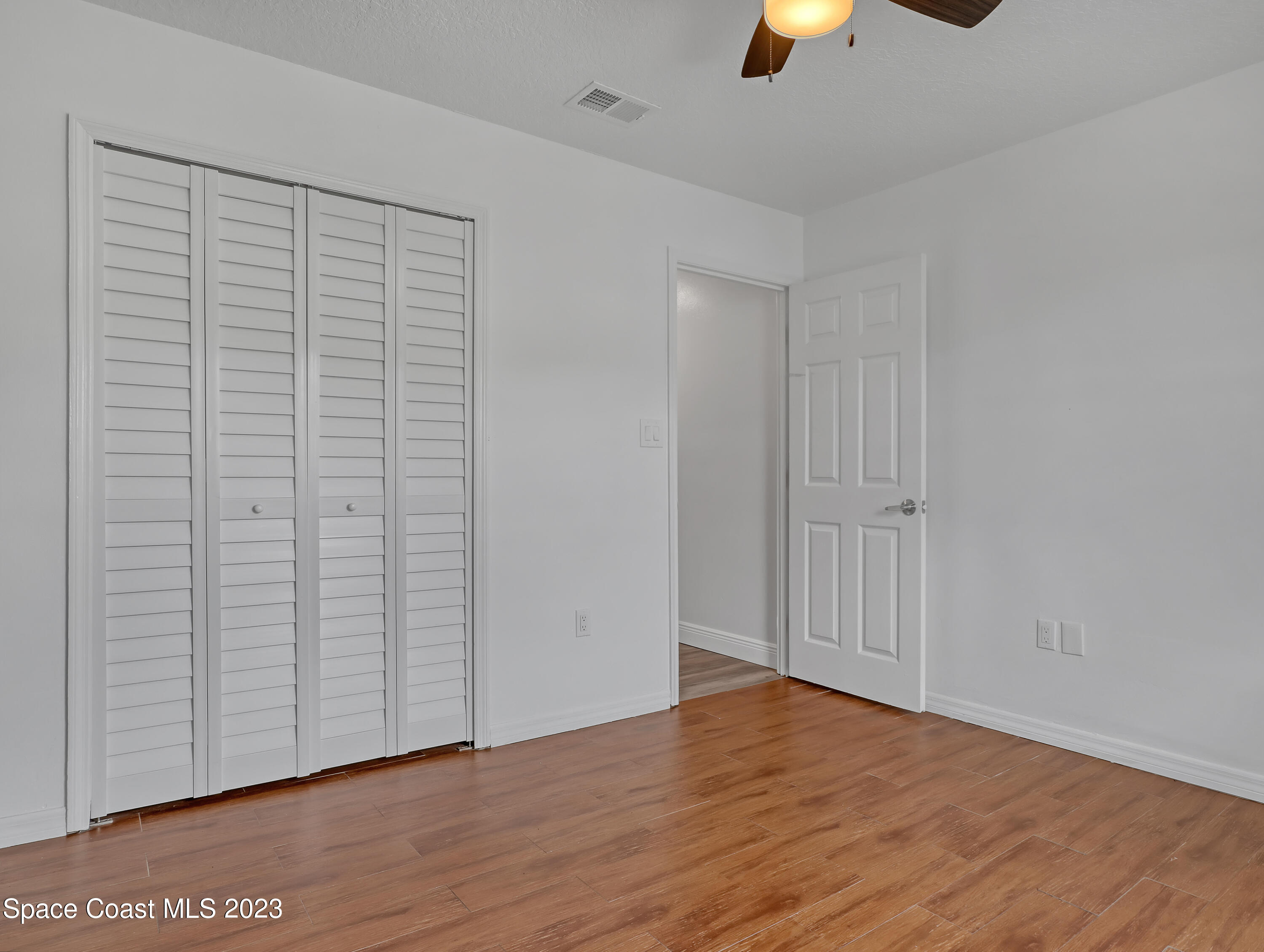5233 Carrick Road Cocoa, FL 32927 - Photo 21 of 32 wooden floor in an empty room