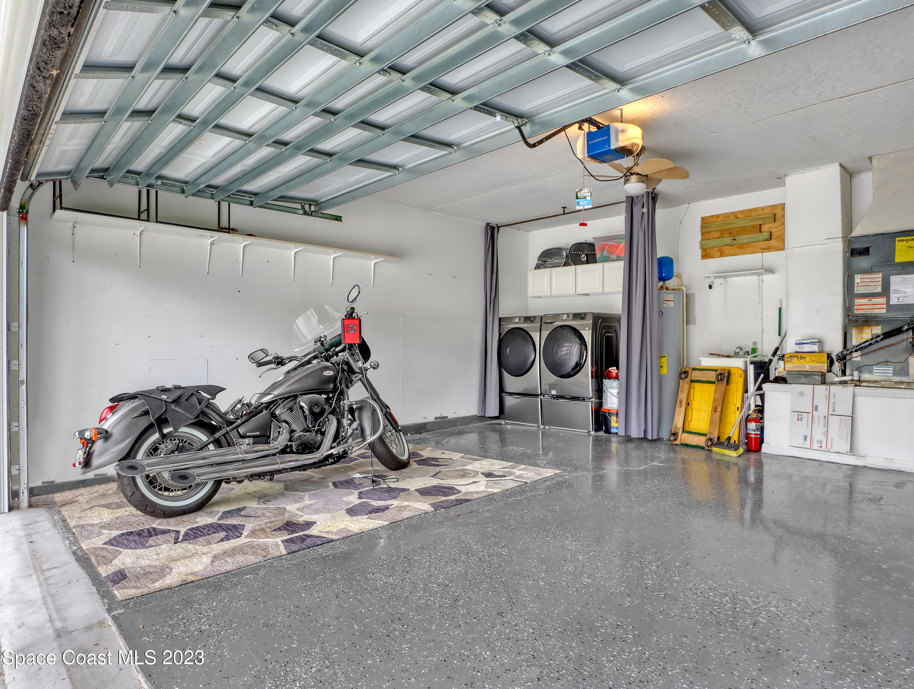 5233 Carrick Road Cocoa, FL 32927 - Photo 22 of 32 a view of a garage with a bike and a roof