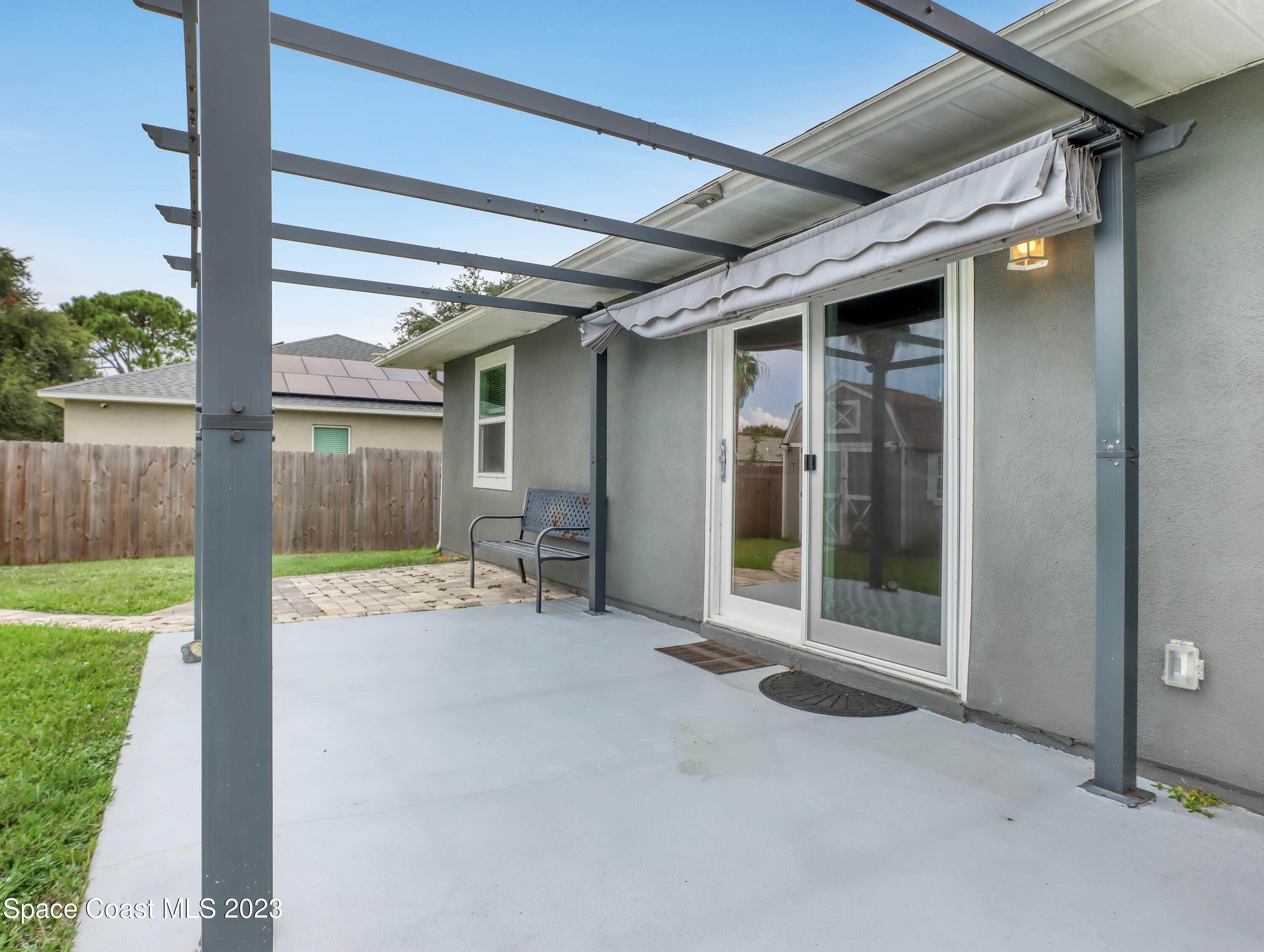 5233 Carrick Road Cocoa, FL 32927 - Photo 25 of 32 a view of a porch with a floor to ceiling window and garden