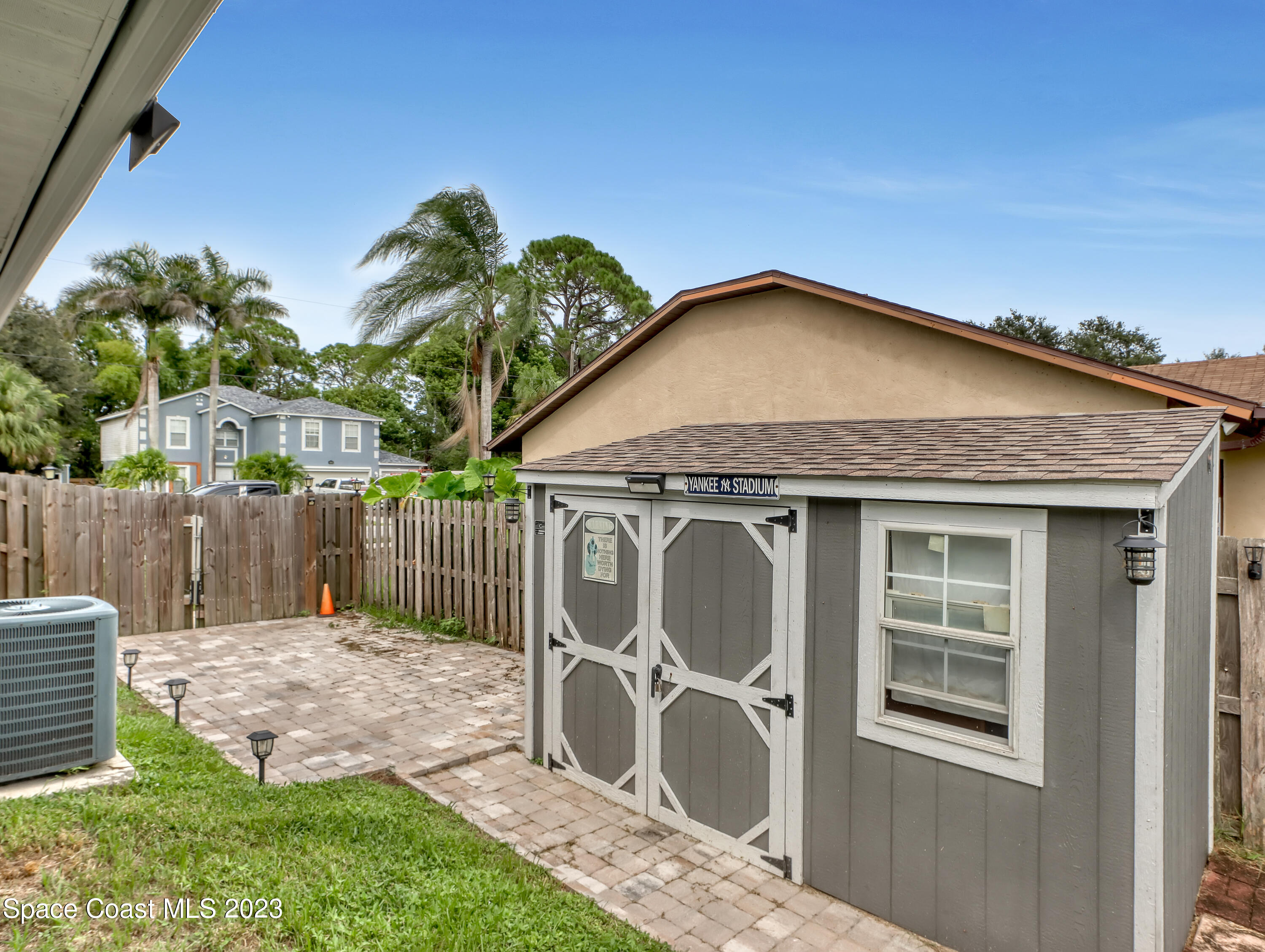 5233 Carrick Road Cocoa, FL 32927 - Photo 30 of 32 a view of a house with a small yard and wooden fence