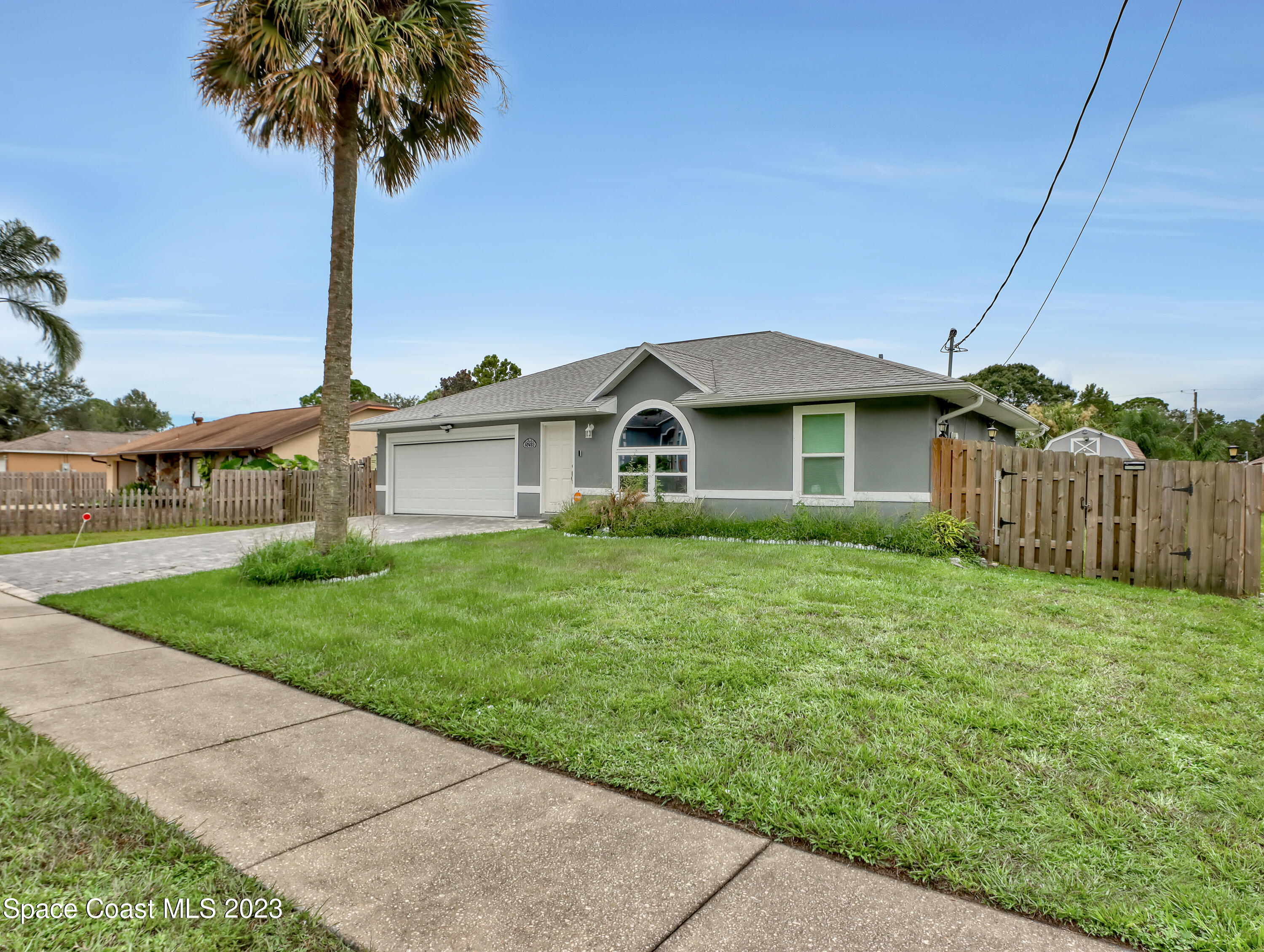 5233 Carrick Road Cocoa, FL 32927 - Photo 3 of 32 a front view of a house with yard and garage