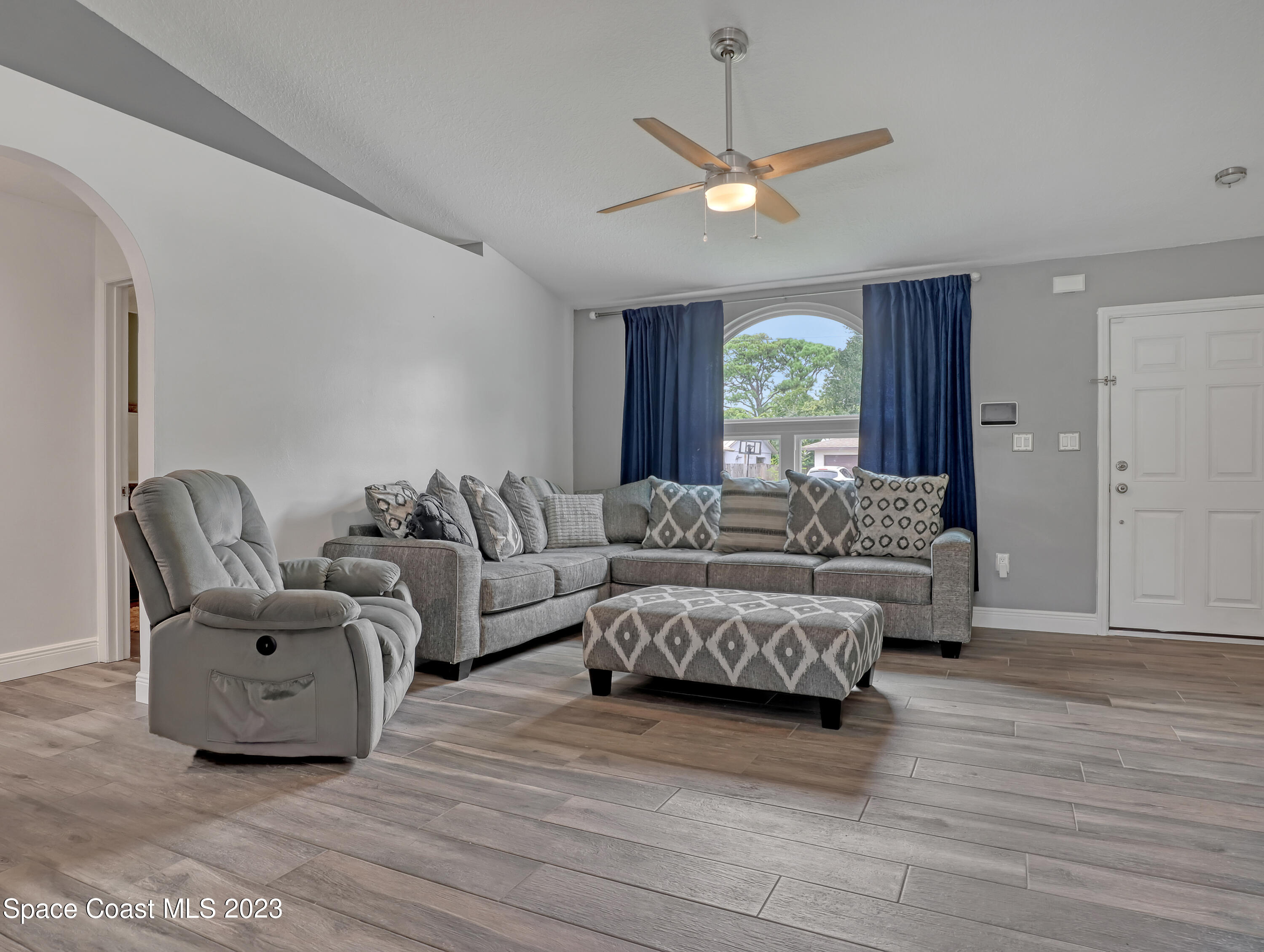 5233 Carrick Road Cocoa, FL 32927 - Photo 4 of 32 a living room with furniture and a large window