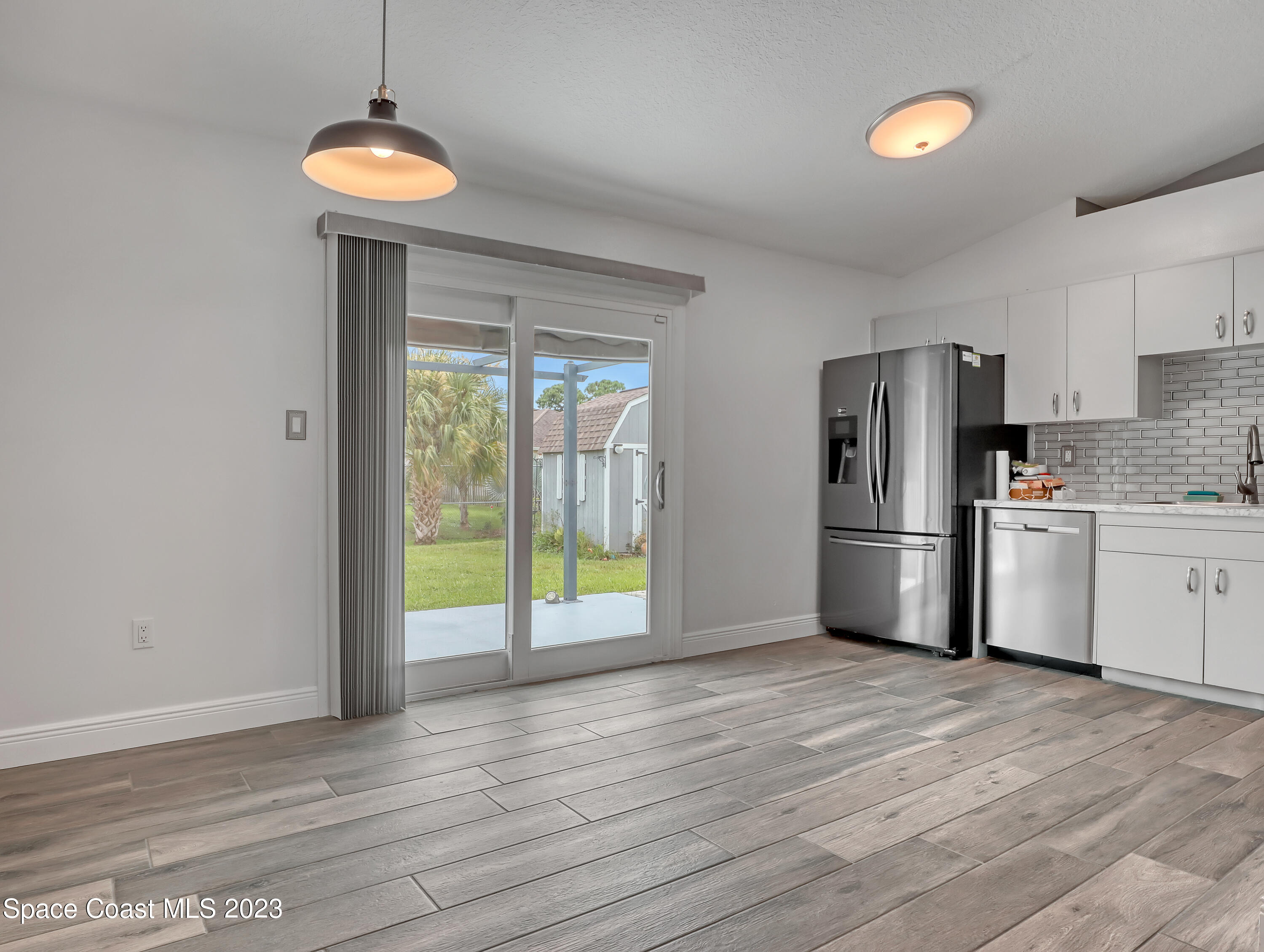 5233 Carrick Road Cocoa, FL 32927 - Photo 7 of 32 a kitchen with stainless steel appliances a refrigerator sink and stove