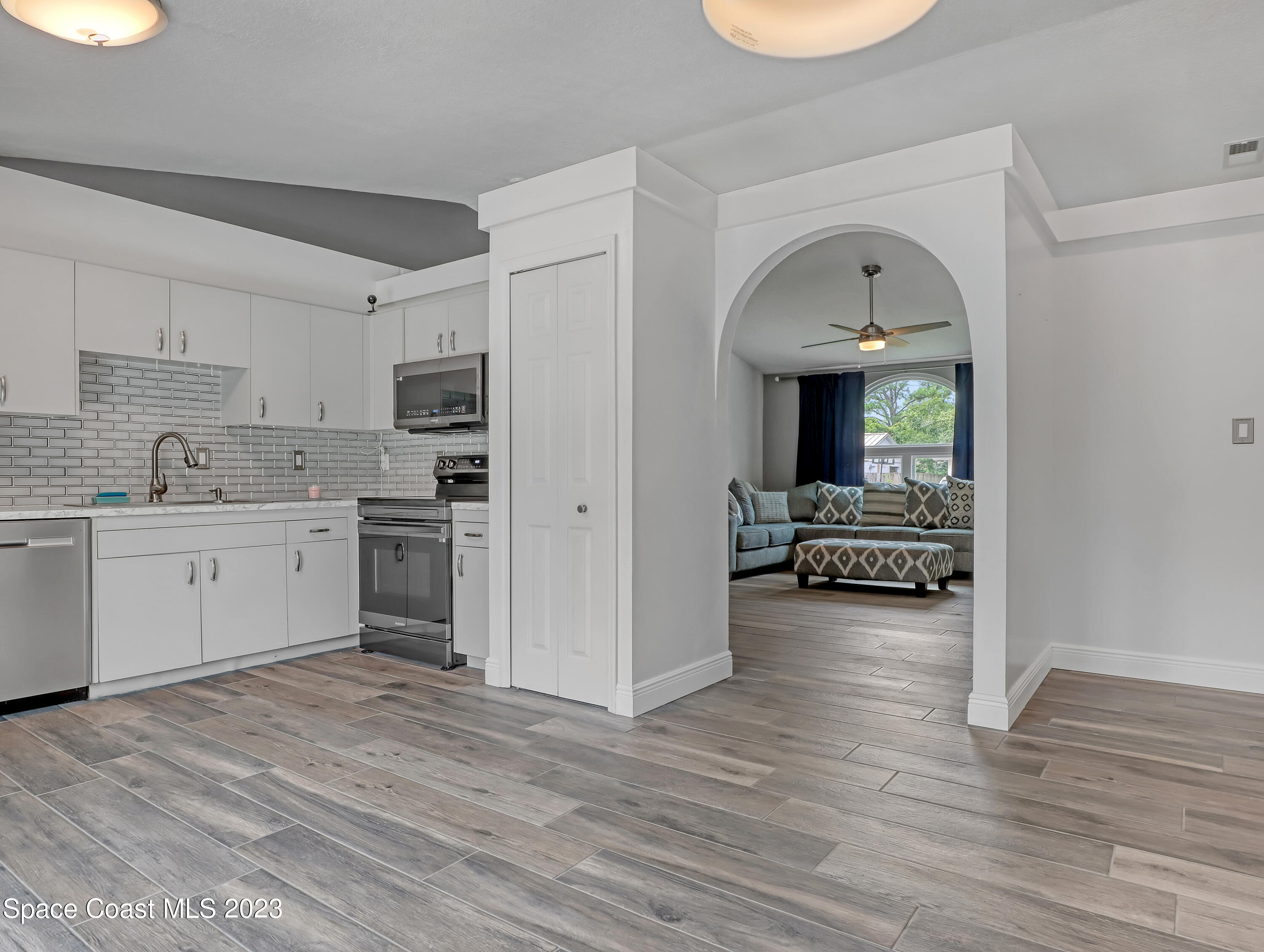 5233 Carrick Road Cocoa, FL 32927 - Photo 8 of 32 a kitchen with a refrigerator and a stove top oven