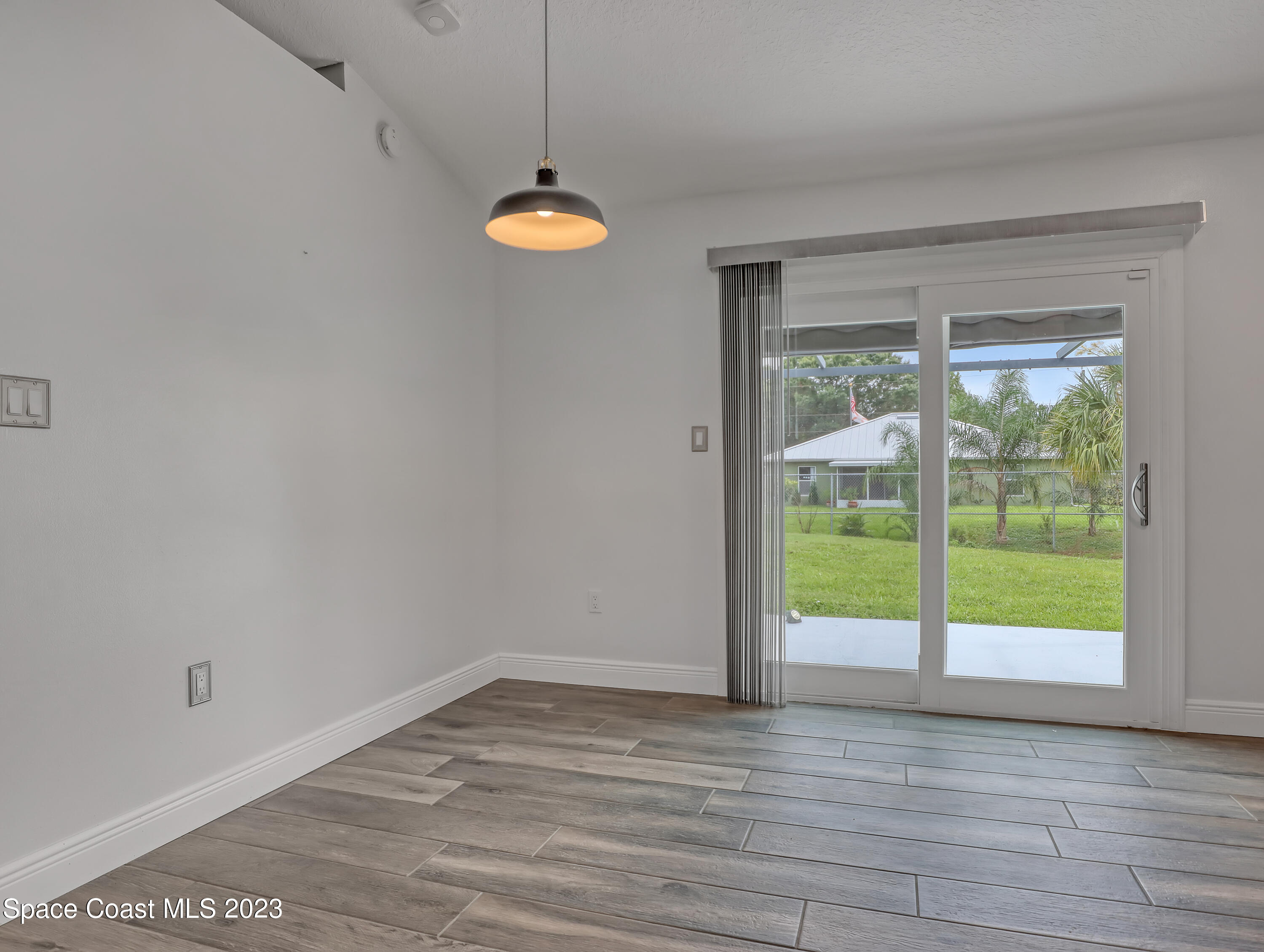 5233 Carrick Road Cocoa, FL 32927 - Photo 9 of 32 wooden floor in an empty room with a window