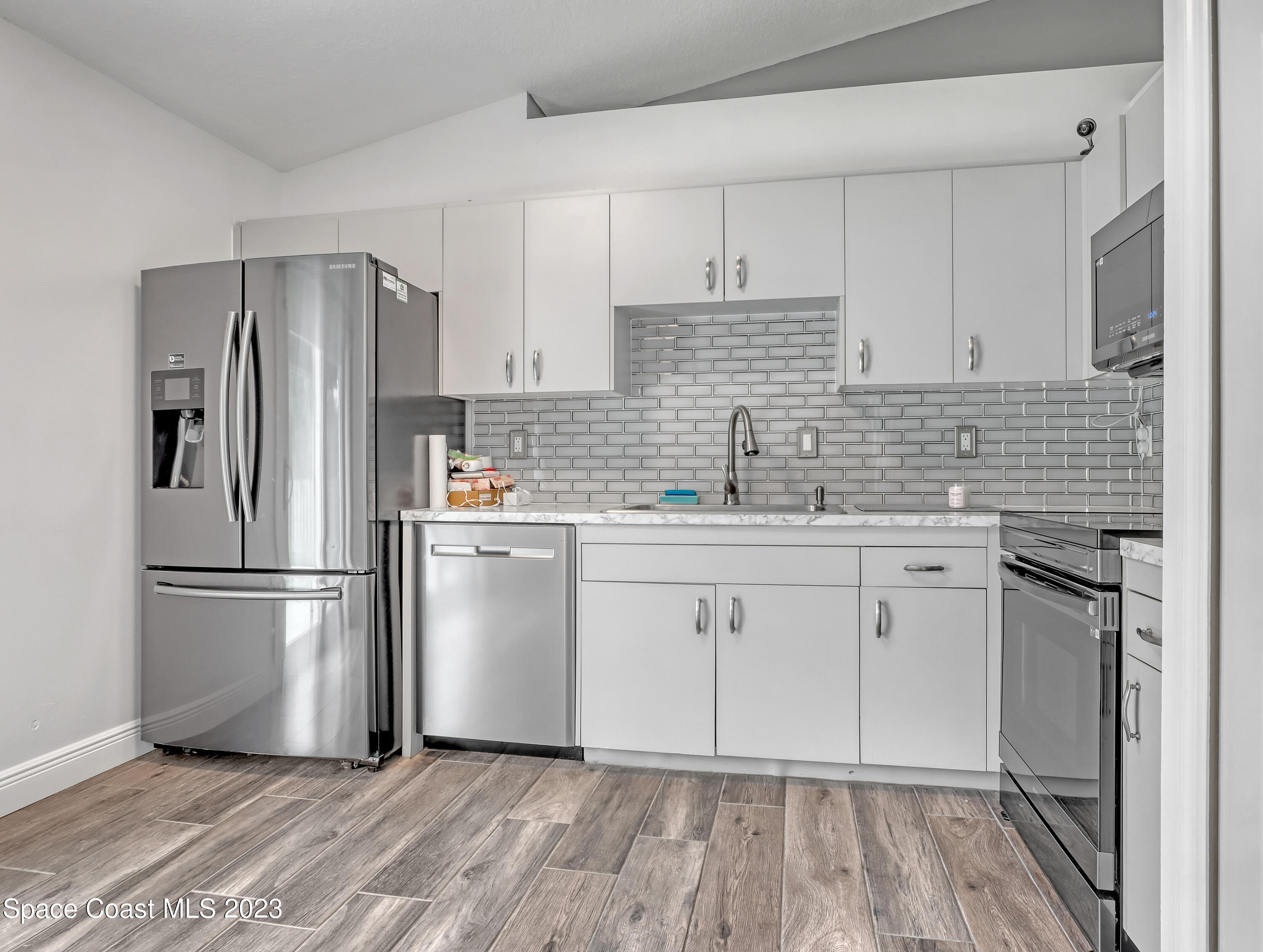 5233 Carrick Road Cocoa, FL 32927 - Photo 10 of 32 a kitchen with appliances a sink and a refrigerator