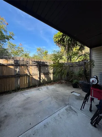 a view of a chairs and table in patio