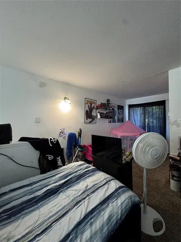 a bedroom with furniture and a lamp