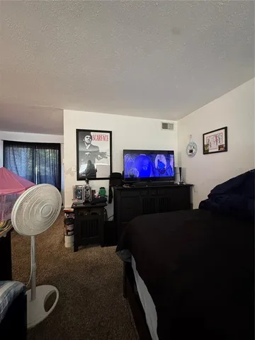 a bedroom with bed and a window