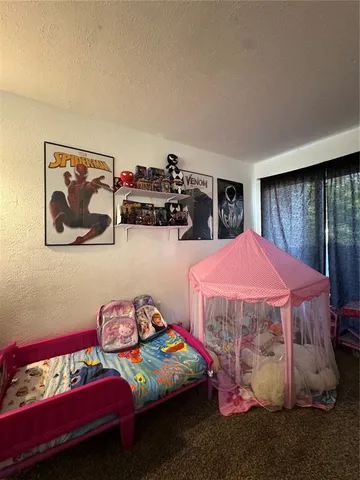 a bedroom with bed and a view of bedroom