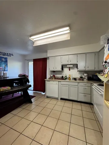 a kitchen with granite countertop cabinets and white stainless steel appliances