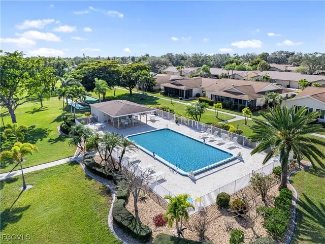 a view of a swimming pool with a yard and mountain view in back