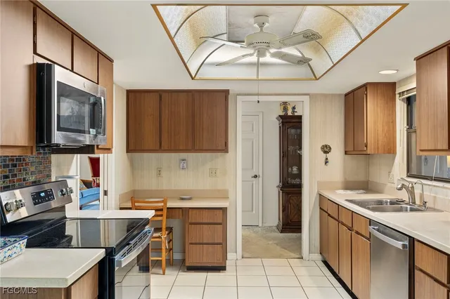 a kitchen with a sink appliances and cabinets