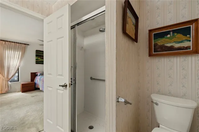 a bathroom with a toilet and a shower