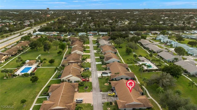 an aerial view of residential houses with outdoor space and street view