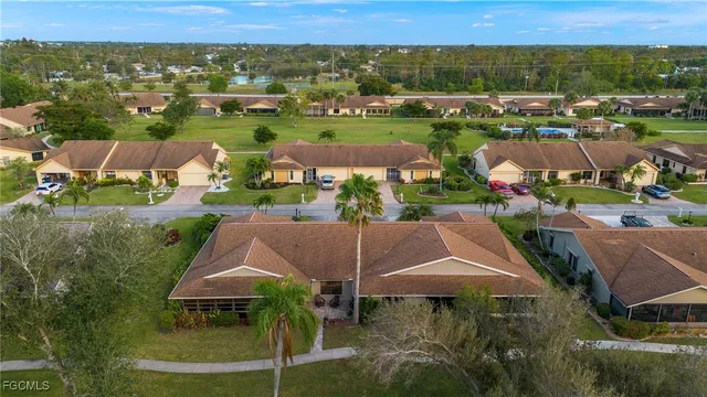 an aerial view of a house with a garden and lake view