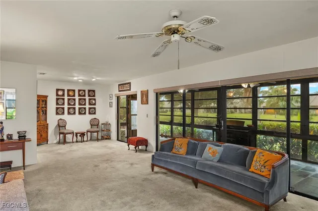 a spacious bedroom with furniture and a large window