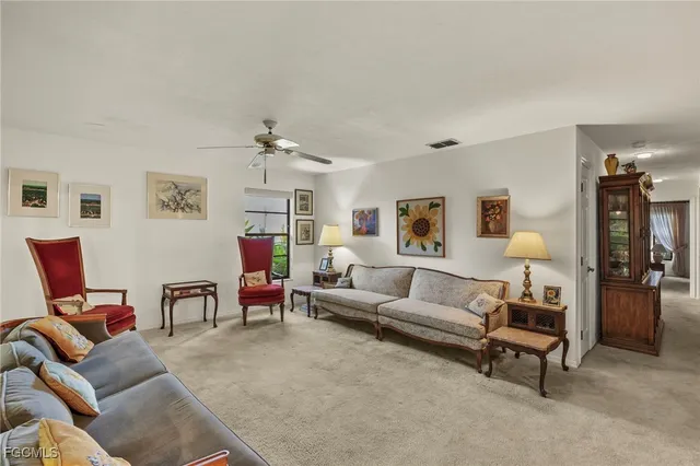 a living room with furniture and a lamp