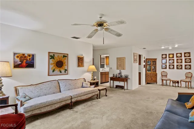a living room with furniture and a ceiling fan