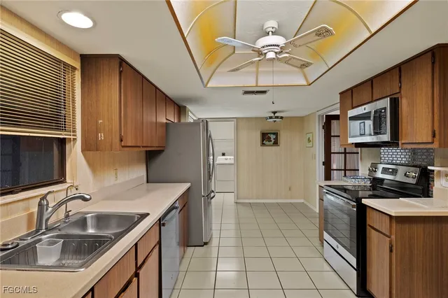 a kitchen with stainless steel appliances granite countertop a sink a stove cabinets and refrigerator