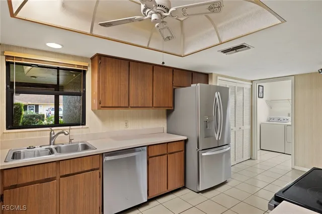 a kitchen with stainless steel appliances granite countertop a refrigerator sink and cabinets