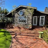 a view of a house with a small yard and plants