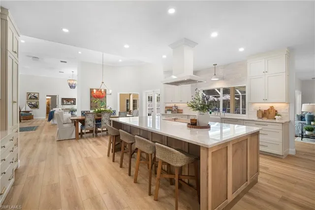 a large kitchen with kitchen island a sink table and chairs