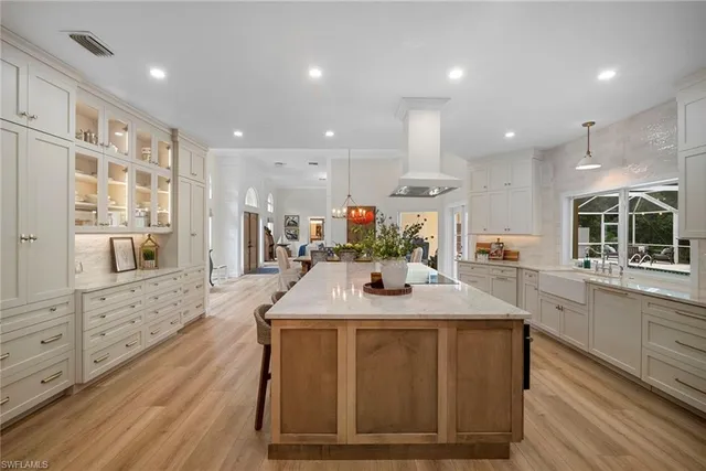 a kitchen with stainless steel appliances kitchen island granite countertop a sink and cabinets