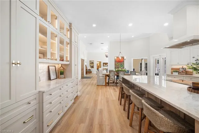 a large kitchen with stainless steel appliances lots of counter space and wooden floor