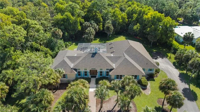 an aerial view of a house with yard and outdoor seating