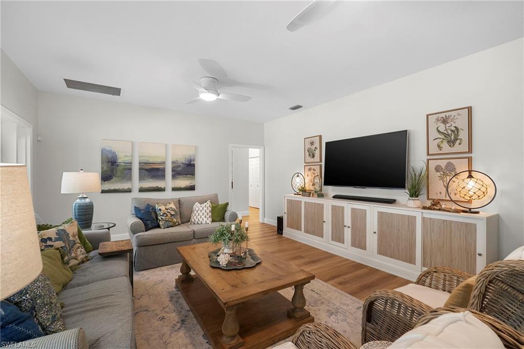 3110 70th Street Southwest Naples, FL 34105 - Photo 22 of 50 a living room with furniture and a flat screen tv