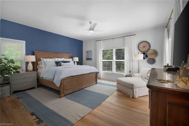 a bedroom with a bed couch and window