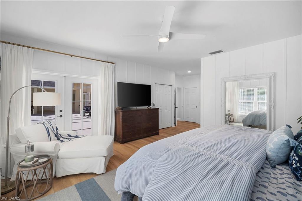 3110 70th Street Southwest Naples, FL 34105 - Photo 25 of 50 a bedroom with a bed and a flat screen tv