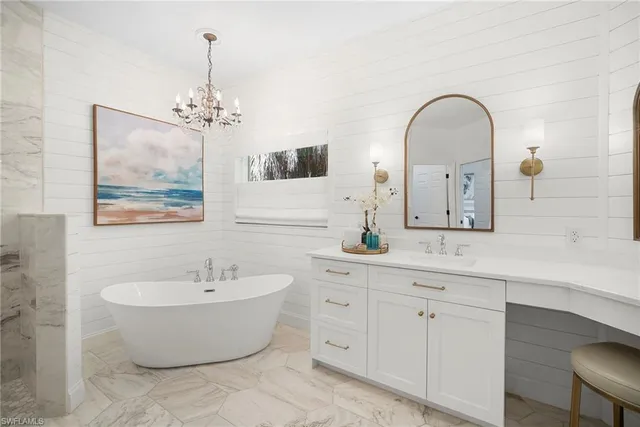 a spacious bathroom with a double vanity sink a mirror and a bathtub