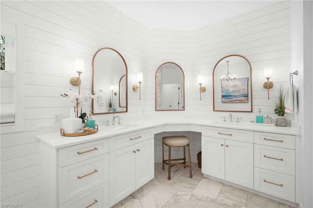3110 70th Street Southwest Naples, FL 34105 - Photo 30 of 50 a bathroom with a double vanity sink and a mirror