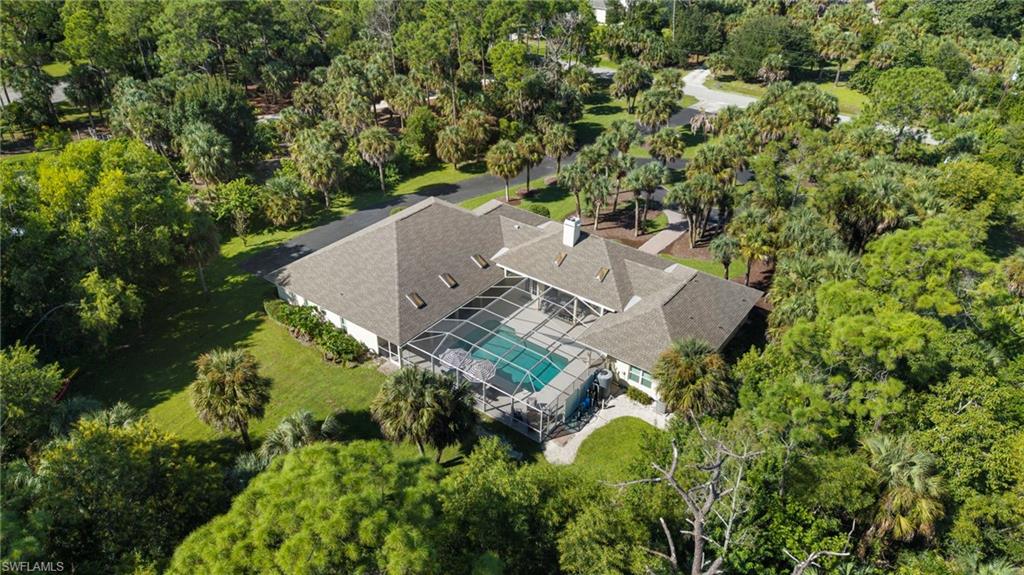 3110 70th Street Southwest Naples, FL 34105 - Photo 3 of 50 an aerial view of a house with a yard and large trees