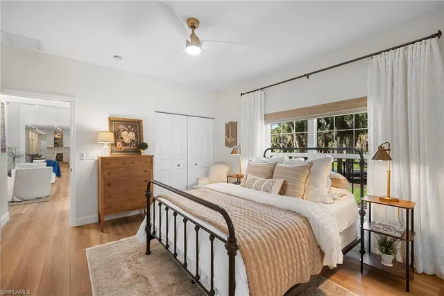 a bedroom with a balcony a bed and a chandelier