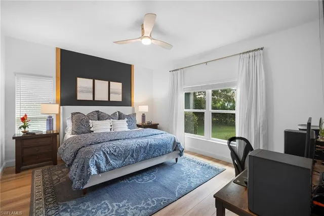 a bedroom with a bed and a table in it