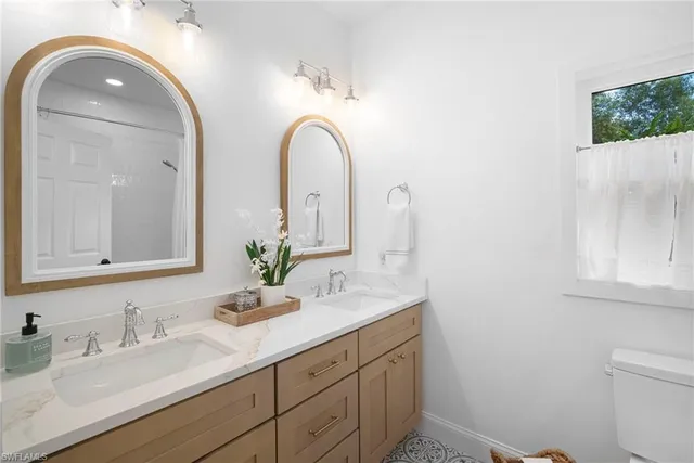 a bathroom with a double vanity sink and a mirror