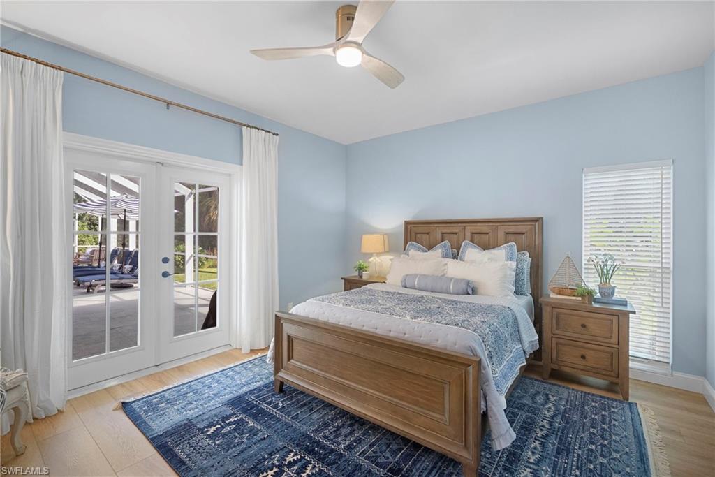 3110 70th Street Southwest Naples, FL 34105 - Photo 39 of 50 a bedroom with a bed wooden floor and a rug