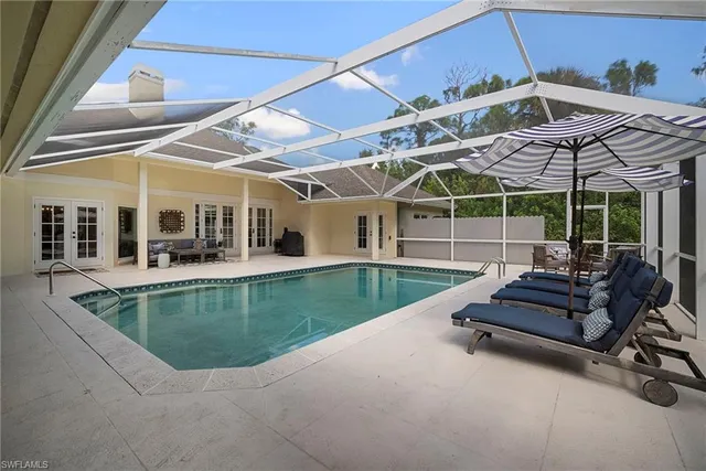 a view of a patio with couches chairs and a small yard