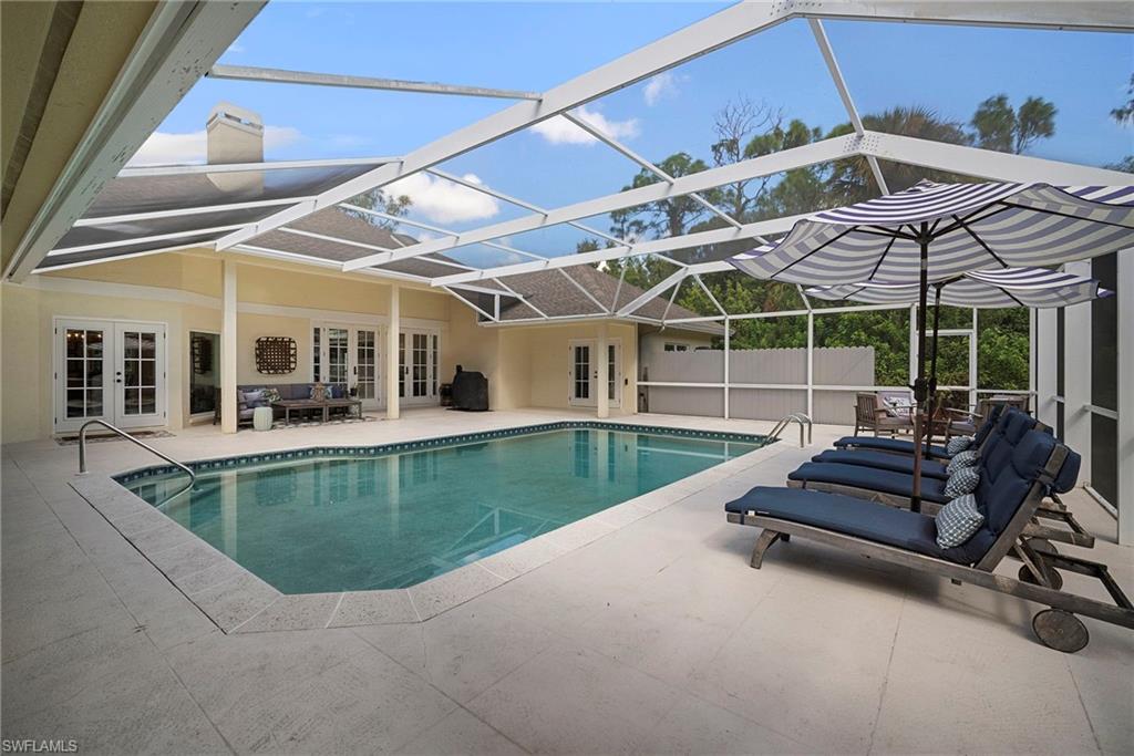 3110 70th Street Southwest Naples, FL 34105 - Photo 47 of 50 a view of a patio with couches chairs and a small yard