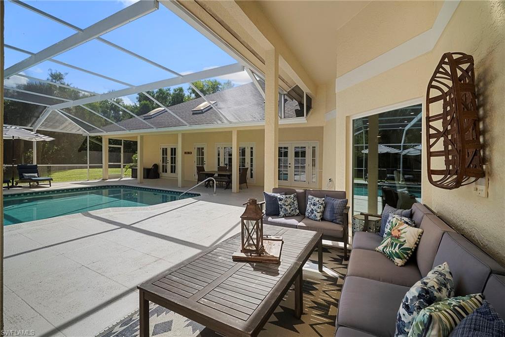 3110 70th Street Southwest Naples, FL 34105 - Photo 49 of 50 a outdoor space with patio the couches and a dining table with the backyard view