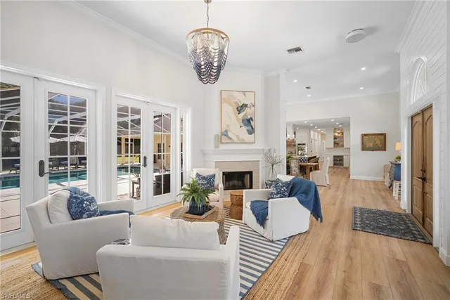a living room with furniture a fireplace and a large window