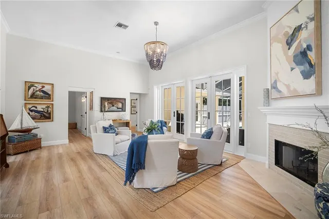 a living room with furniture a fireplace and wooden floor