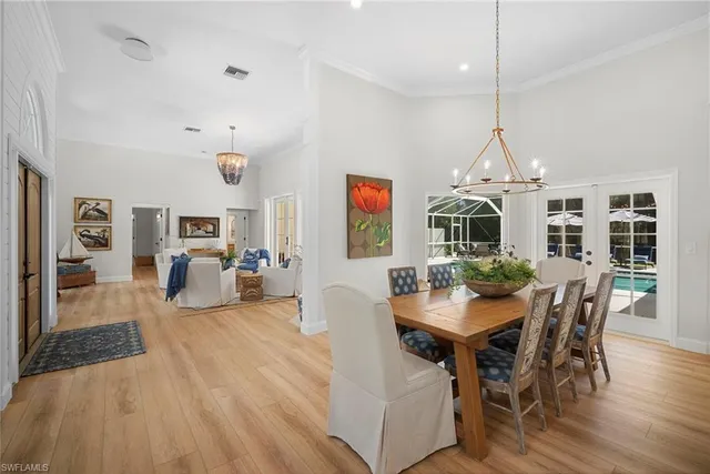 a view of a dining room with furniture wooden floor and chandelier