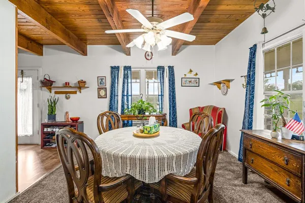 a living room with furniture a fireplace and a chandelier